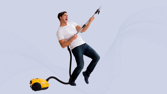 man playing air guitar with vacuum 