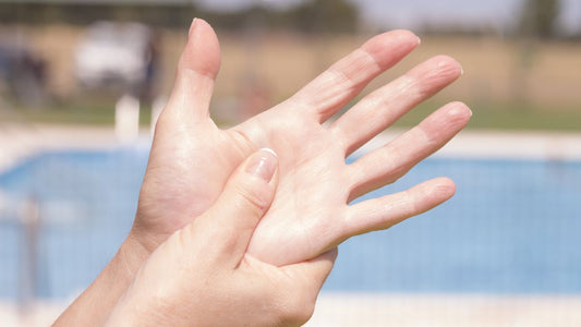 Pressure point on hand being squeezed by another hand