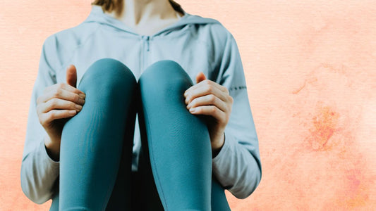 woman in teal leggings pressing on Zusanli ST-36 point