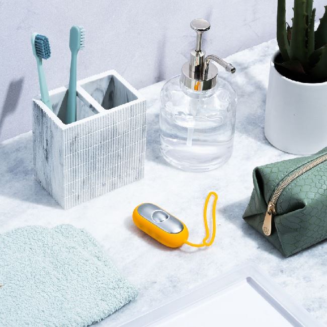 The Chill Pill device placed beside a bathroom sink with toiletries, emphasizing daily use.