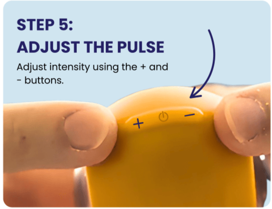 Thumbs pressing the intensity adjust and power buttons on the Chill Pill Plus